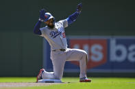 Los Angeles Dodgers' Teoscar Hernández (37) celebrates after hitting an RBI-double during the first inning of a baseball game against the Minnesota Twins, Wednesday, April 10, 2024, in Minneapolis. (AP Photo/Abbie Parr)