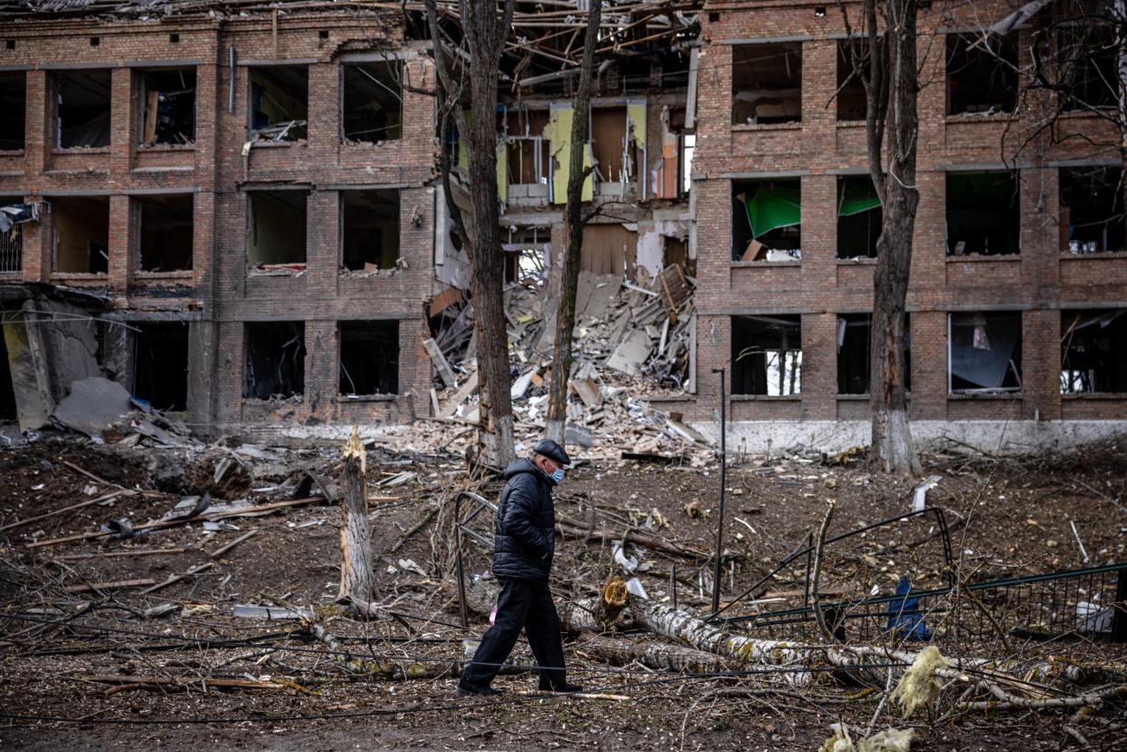 A man walks in front of a destroyed building after a Russian missile attack in Vasylkiv, Ukraine.