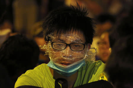 A protester wearing rudimentary protection against pepper spray is pictured during a confrontation with the police, after a rally for the October 1 "Occupy Central" civil disobedience movement in Hong Kong September 27, 2014. REUTERS/Bobby Yip