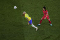 Brazil's Richarlison, left, heads the ball next to South Korea's Kim Young-gwon during the World Cup round of 16 soccer match between Brazil and South Korea, at the Stadium 974 in Doha, Qatar, Monday, Dec. 5, 2022.(AP Photo/Darko Bandic)