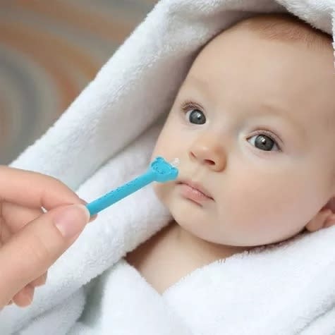 Adult uses the extractor on a baby