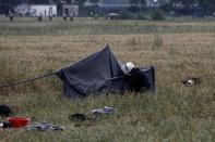 A riot policeman checks a tent during a police operation at a refugee camp at the border between Greece and Macedonia, near the village of Idomeni, Greece, 24 May 2016. REUTERS/Yannis Kolesidis/Pool