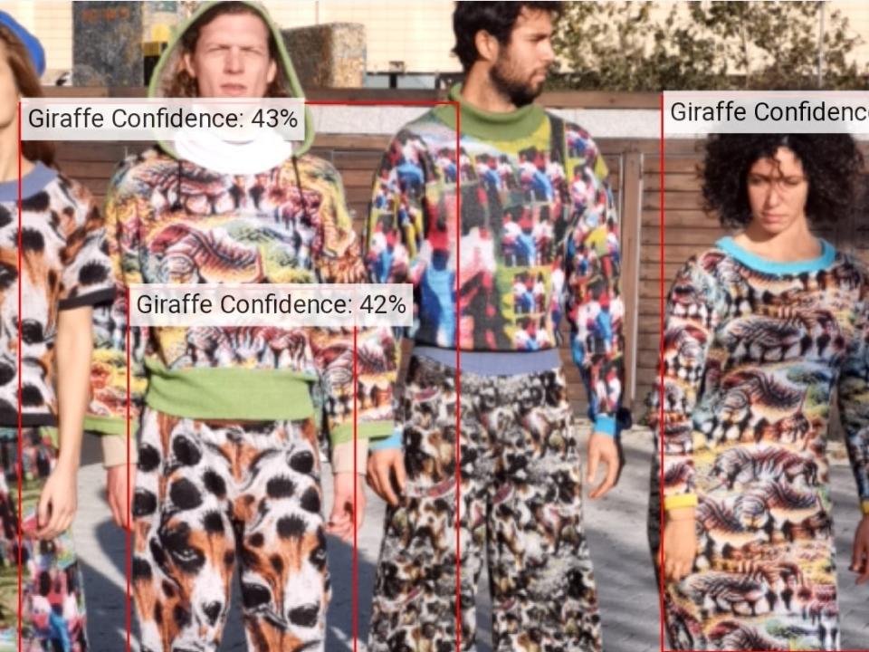 Facial recognition software analysis of people dressed in Cap_able's vibrant outfits shows detection as giraffes