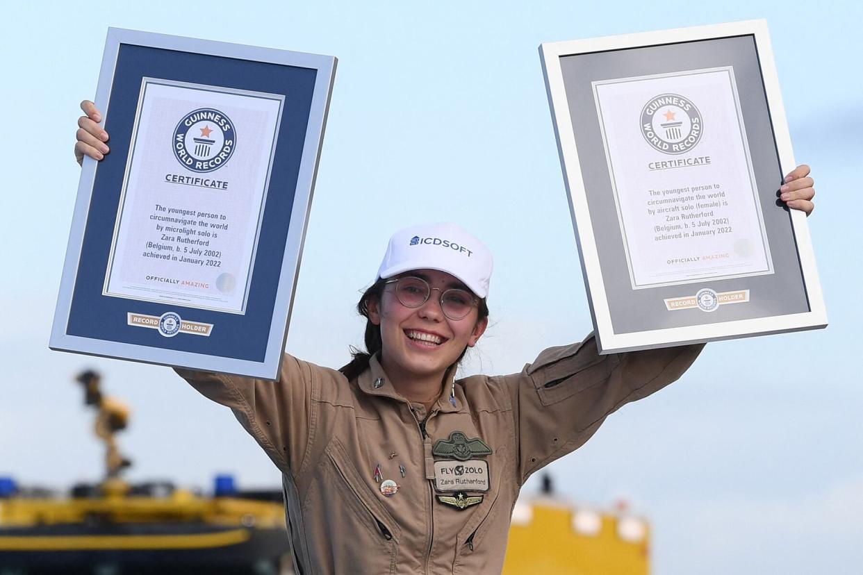 Belgian-British teenage pilot Zara Rutherford, aboard her a Shark ultralight, holds certificates after landing back at the end of her solo round-the-world trip in her Belgian home town of Kortrijk