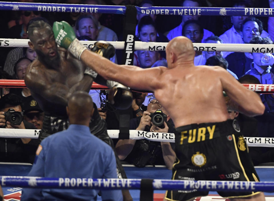 LAS VEGAS, NV - FEBRUARY 22: (in black//yellow trunks) Tyson Fury  goes 7 rounds with Deontay Wilder at the MGM Grand Hotel February 22, 2020 in Las Vegas, Nevada.   Tyson Fury took the win by TKO in the 7th round as the towel was thrown in by the Wilder team for the world heavyweight championship in Las Vegas, Nevada. (Photo by MB Media/Getty Images)