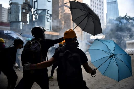 Hong Kong's pro-democracy activists use umbrellas to shield themselves from rubber bullets and tear gas