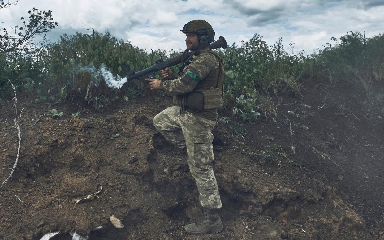 A Ukrainian soldier fires an RPG toward Russian positions at the frontline near Bakhmut - LIBKOS/AP