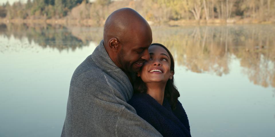 Preacher and Kaia embrace by the lake.