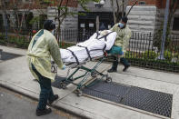 FILE —In this April 17, 2020, file photo, a patient is prepared to be loaded into the back of an ambulance by emergency medical workers outside Cobble Hill Health Center in the Brooklyn borough of New York. Cuomo also ordered nursing homes to accept recovering coronavirus patients to free up hospital beds, a move since blamed for the rapid spread of the disease in those facilities. More than 6,400 people have died of coronavirus in New York nursing homes, and the policy was later rescinded — though state officials argued it was employees who were causing the outbreaks. (AP Photo/John Minchillo, File)