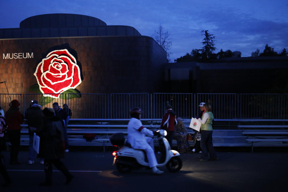 A Tournament member rides a scooter down the parade route in the early morning hours prior to the start of the 124th Rose Parade in Pasadena, Calif., Tuesday, Jan. 1, 2013. (AP Photo/Patrick T. Fallon)