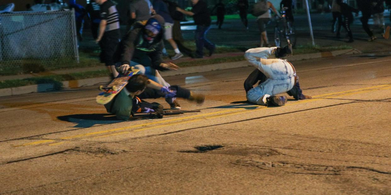 KENOSHA, WISCONSIN, USA - AUGUST 25: Clashes between protesters and armed civilians, who protect the streets of Kenosha against the arson, break out during the third day of protests over the shooting of a black man Jacob Blake by police officer in Wisconsin, United States on August 25, 2020. (Photo by Tayfun Coskun/Anadolu Agency via Getty Images)