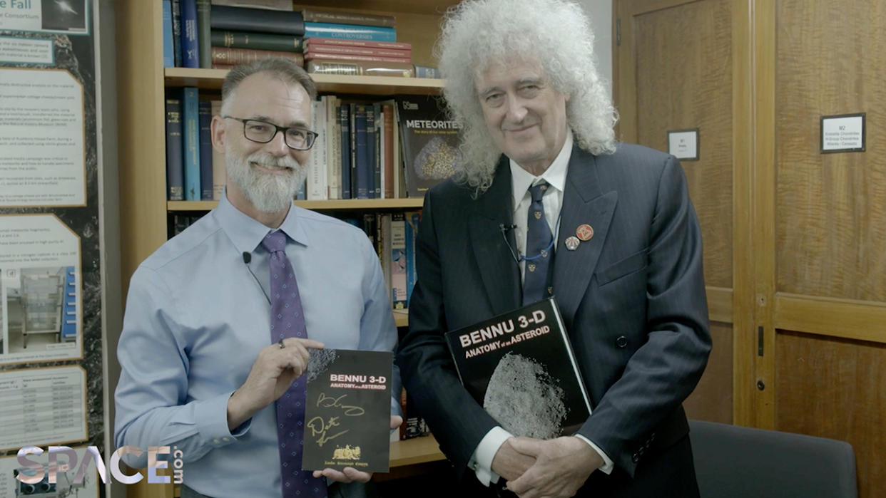  Brian May and Dante Lauretta, the principal investigator of NASA's OSIRIS-REx mission posing with a new book on asteroid Bennu. 