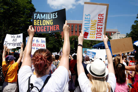 FILE PHOTO: Immigration activists hold signs against family separation during a rally to protest against the Trump Administration's immigration policy outside the White House in Washington, U.S., June 30, 2018. REUTERS/Joshua Roberts/File Photo