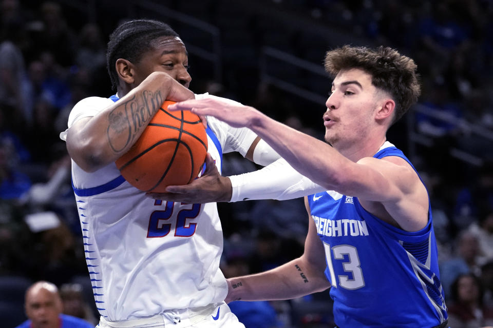 DePaul guard Elijah Fisher, left, grabs a rebound against Creighton forward Mason Miller during the first half of an NCAA college basketball game in Chicago, Tuesday, Jan. 9, 2024. (AP Photo/Nam Y. Huh)