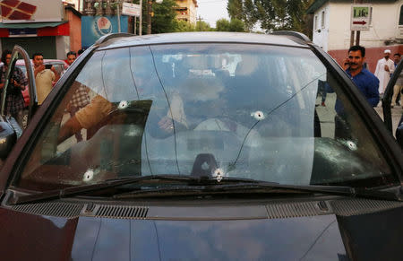 Bullet marks are seen on the car of Syed Shujaat Bukhari, the editor of Rising Kashmir daily newspaper, after unidentified gunmen attacked him outside his office in Srinagar, June 14, 2018. REUTERS/Stringer