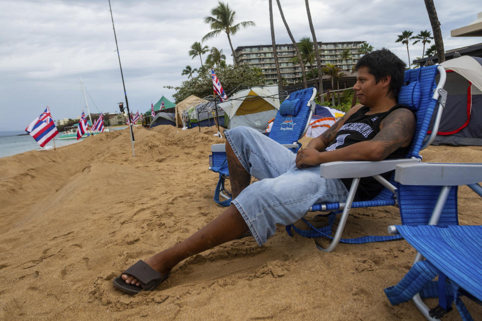 FILE - Carlos Lamas looks out to the sea from his spot at the "Fish-in" protest on, Friday, Dec. 1, 2023, in Lahaina, Hawaii. Lahaina Strong has set up a "Fish-in" to protest living accommodations for those displaced by the Aug. 8, 2023 wildfire, the deadliest U.S. wildfire in more than a century. (AP Photo/Ty O'Neil, File)