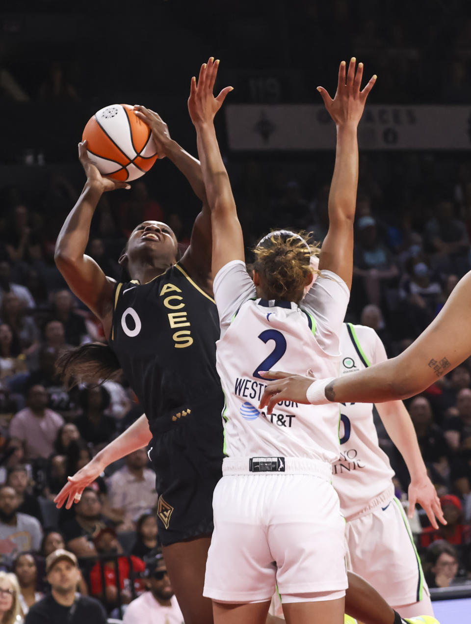Las Vegas Aces guard Jackie Young (0) shoots around Minnesota Lynx guard Evina Westbrook (2) during the second half of a WNBA basketball game Sunday, June 19, 2022, in Las Vegas. (Chase Stevens/Las Vegas Review-Journal via AP)