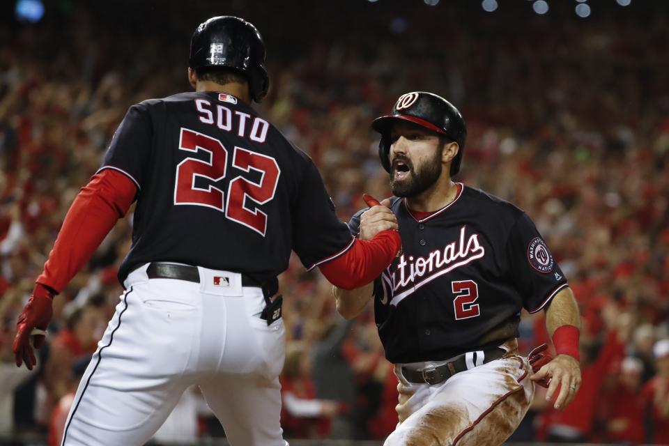 Washington Nationals' Adam Eaton celebrates with Juan Soto (22) after scoring on a hit by -Anthony Rendon during the third inning of Game 3 of the baseball National League Championship Series against the St. Louis Cardinals Monday, Oct. 14, 2019, in Washington. (AP Photo/Jeff Roberson)