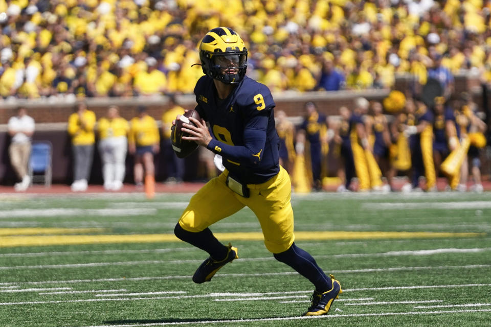 Michigan quarterback J.J. McCarthy rolls out to pass against East Carolina in the first half of an NCAA college football game in Ann Arbor, Mich., Saturday, Sept. 2, 2023. (AP Photo/Paul Sancya)