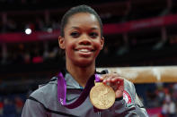 Gabrielle Douglas of the United States celebrates on the podium after winning the gold medal in the Artistic Gymnastics Women's Individual All-Around final on Day 6 of the London 2012 Olympic Games at North Greenwich Arena on August 2, 2012 in London, England. (Photo by Ronald Martinez/Getty Images)