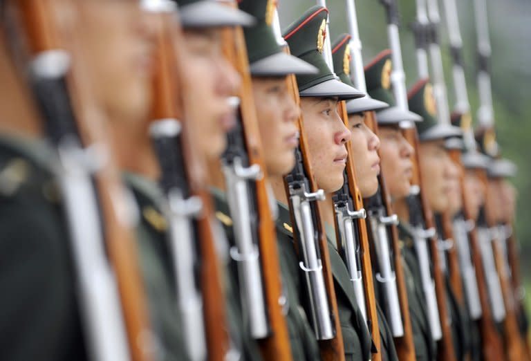 Soldiers of the Guards of Honour of the Three Services of the Chinese People's Liberation Army (PLA) stand at attention during a training session at a barracks in Beijing on July 21, 2011. China's army controls some of the most prolific hackers in the world, according to a new report Tuesday by an Internet security firm that traced a host of cyberattacks to an anonymous building in Shanghai