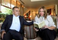 Carole Ghosn, wife of Fugitive former car executive Carlos Ghosn, holds their latest book 'Ensemble toujours' during an interview with Reuters in Beirut