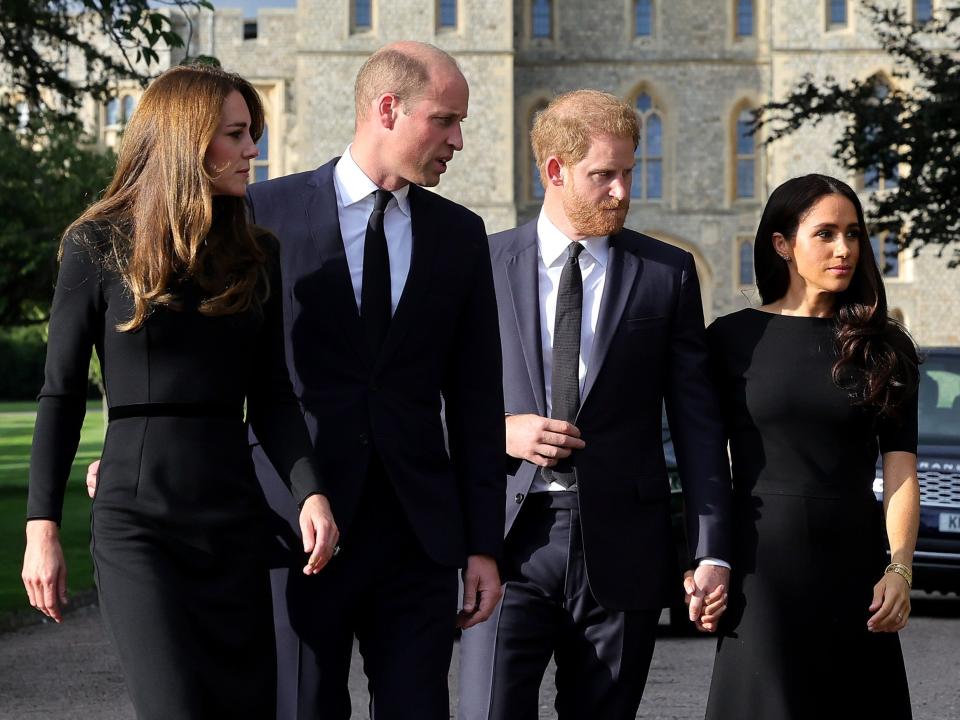 Kate Middleton, Prince William, Prince Harry, and Meghan Markle all wearing black.