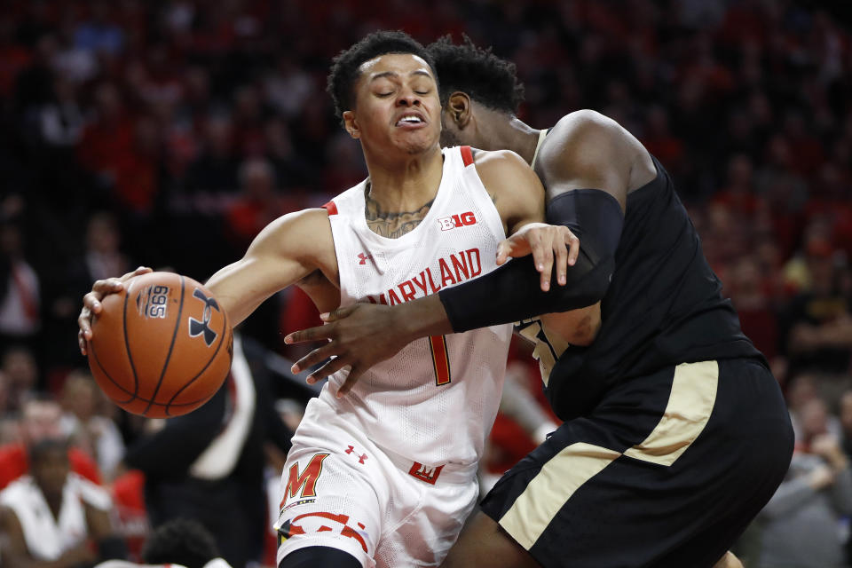 Maryland guard Anthony Cowan Jr. (1) drives against Purdue forward Trevion Williams during the first half of an NCAA college basketball game, Saturday, Jan. 18, 2020, in College Park, Md. (AP Photo/Julio Cortez)