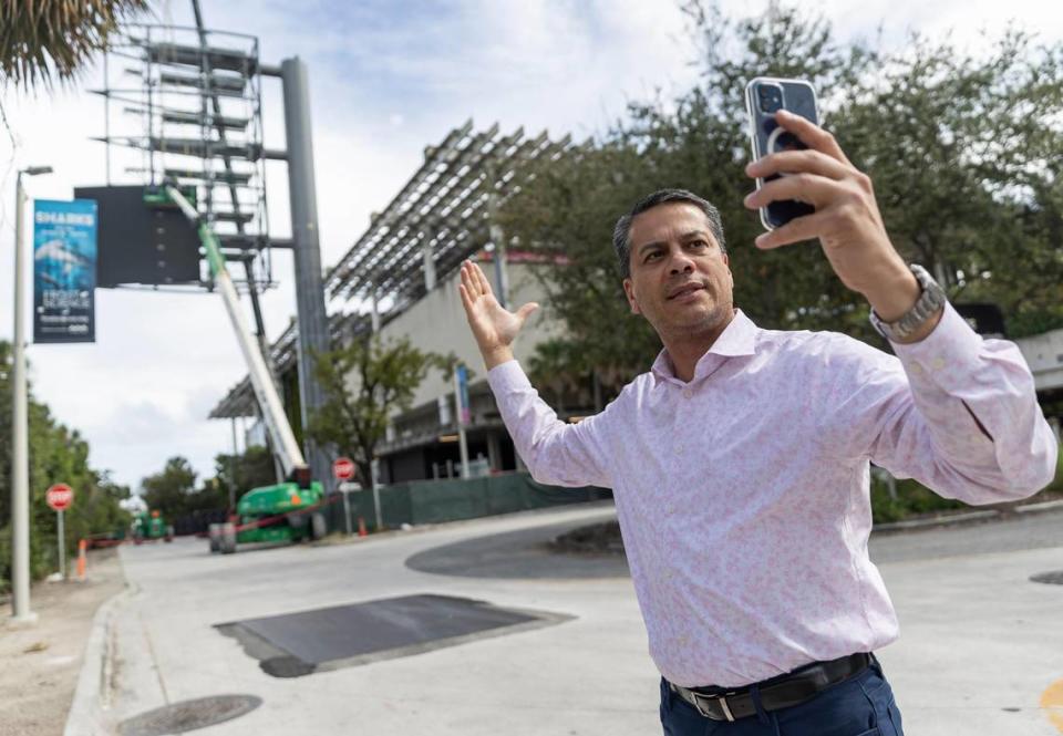 James Torres, 52, the president of the Downtown Neighbors Alliance, records a video of a billboard that is being constructed next to the Pérez Art Museum Miami on Friday, Jan. 26, 2024, in downtown Miami. Torres and the Miami DNA are opposed to the construction of the 10-story LED billboard, which will have bright panels facing incoming traffic riding the MacArthur Causeway from the east and west.