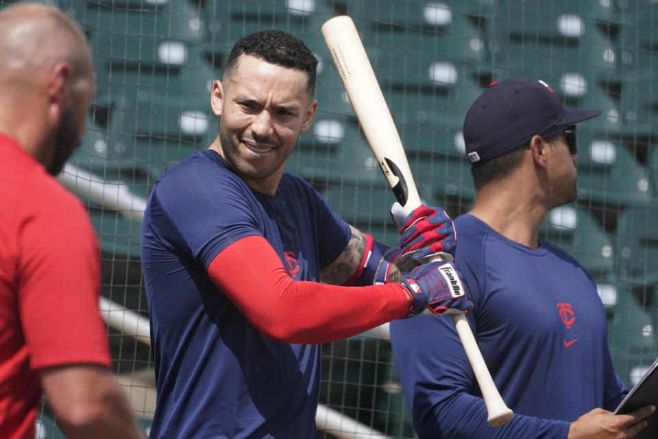 Minnesota Twins' Carlos Correa stretches as he gets ready for baseball batting practice at Hammond Stadium Wednesday, March 23, 2022, in Fort Myers, Fla. (AP Photo/Steve Helber)