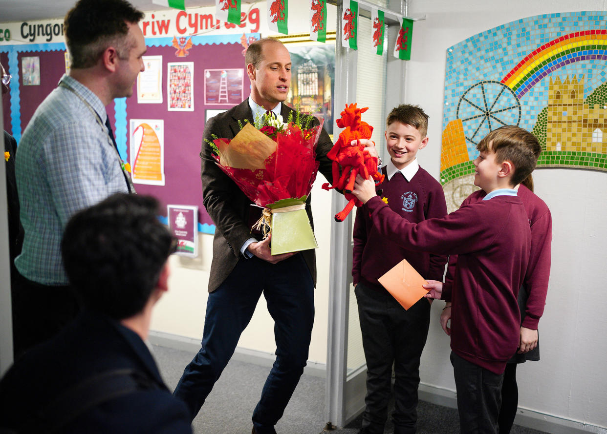 Prince William Receives Gifts for His Children, Flowers for Wife From Students at Welsh School