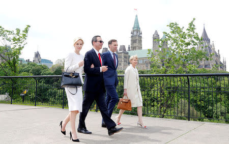 FILE PHOTO: U.S. Secretary of the Treasury Steven Mnuchin (2nd L), his fiancee Louise Linton (L), Canada's Finance Minister Bill Morneau (2nd R) and his wife Nancy McCain walk past Parliament Hill on their way to a meeting, in Ottawa, Canada, June 9, 2017. REUTERS/Patrick Doyle/File Photo