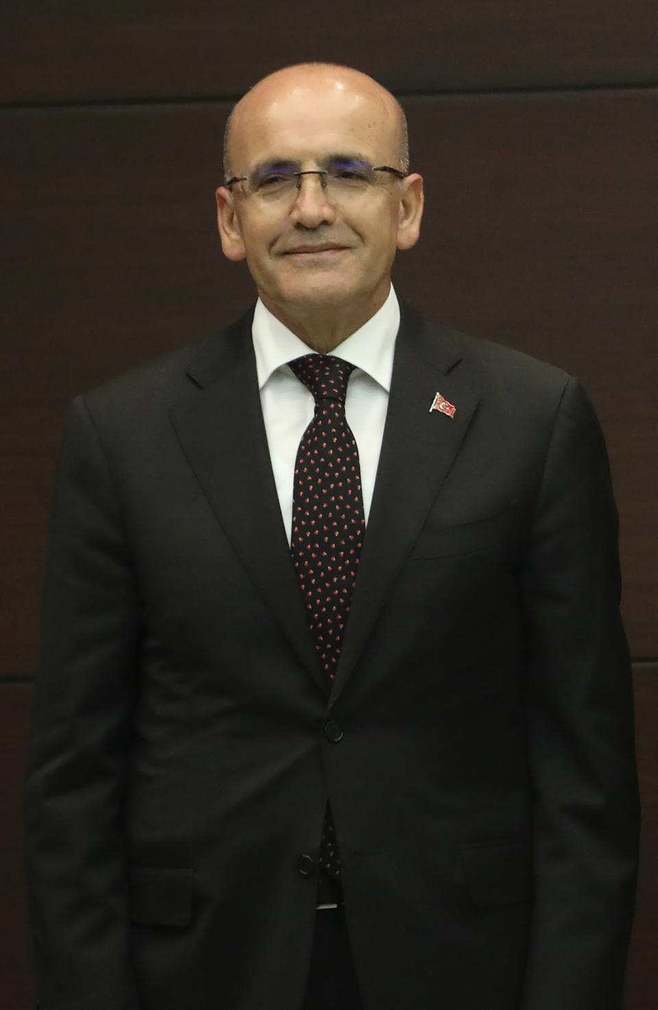 Turkey's new treasury and finance minister Mehmet Simsek, stands during the inauguration ceremony at the presidential complex in Ankara, Turkey, Saturday, June 3, 2023. Turkey's Recep Tayyip Erdogan, who was sworn into his third presidential term on Saturday, reappointed an internationally respected former banker as finance minister in a sign that his new government might pursue more conventional economic policies. (Yavuz Ozden/dia images via AP)