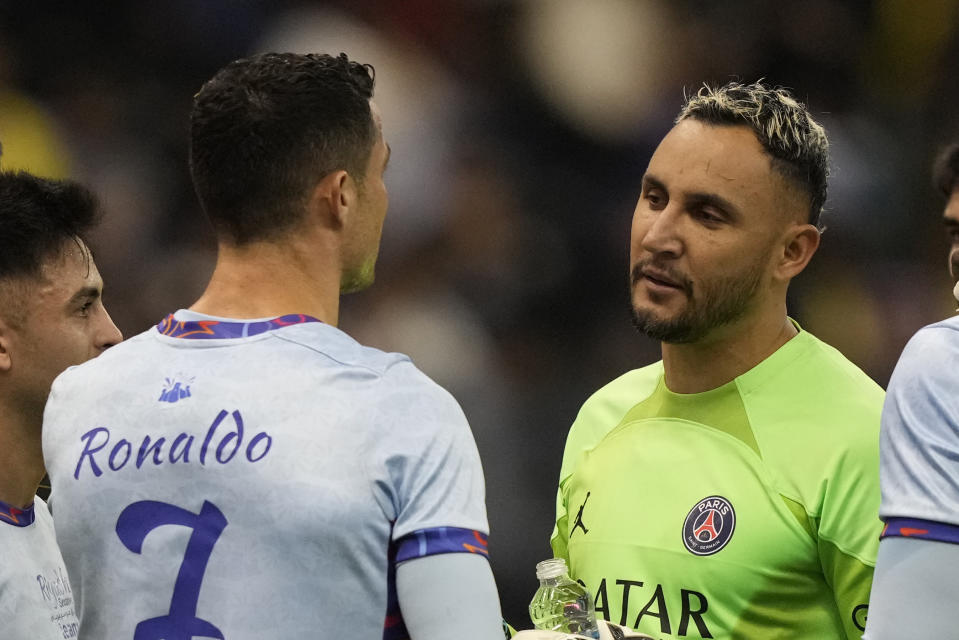 Cristiano Ronaldo talks with PSG's goalkeeper Keylor Navas as he plays for a combined XI of Saudi Arabian teams Al Nassr and Al Hilal against PSG during a friendly soccer match, at the King Saud University Stadium, in Riyadh, Saudi Arabia, Thursday, Jan. 19, 2023. (AP Photo/Hussein Malla)