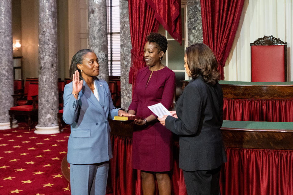 Sen. Laphonza Butler, D-Calif., raises her right hand, with her wife Neneki Lee looking on, as Vice President Kamala Harris recites the oath during her ceremonial swearing-in in the Old Senate Chamber in Washington, D.C. on Oct. 3, 2023.  / Credit: Bill Clark/CQ-Roll Call, Inc via Getty Images