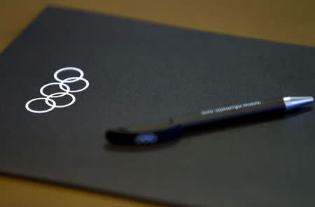 A folder and a pen are pictured on a table before the start of the Executive Board meeting at the International Olympic Committee (IOC) headquarters in Lausanne, Switzerland December 8, 2015. REUTERS/Denis Balibouse