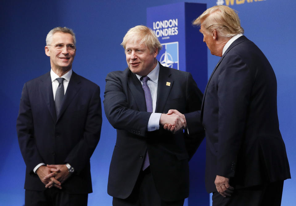 NATO Secretary General Jens Stoltenberg, left, and British Prime Minister Boris Johnson, center, greet U.S. President Donald Trump during official arrivals at a NATO leaders meeting at The Grove hotel and resort in Watford, Hertfordshire, England, Wednesday, Dec. 4, 2019. NATO Secretary-General Jens Stoltenberg rejected Wednesday French criticism that the military alliance is suffering from brain death, and insisted that the organization is adapting to modern challenges. (Peter Nicholls, Pool Photo via AP)