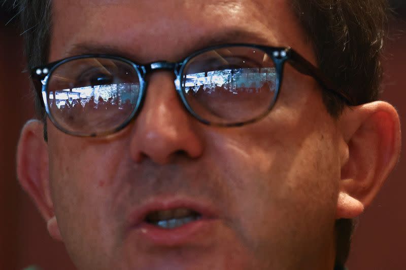 Journalists are seen reflected of the glasses of Pedro Stretch, child psychiatrist and head of the commission investigating allegations of historical child sexual abuse by members of the Portuguese Catholic church, during a news conference in Lisbon