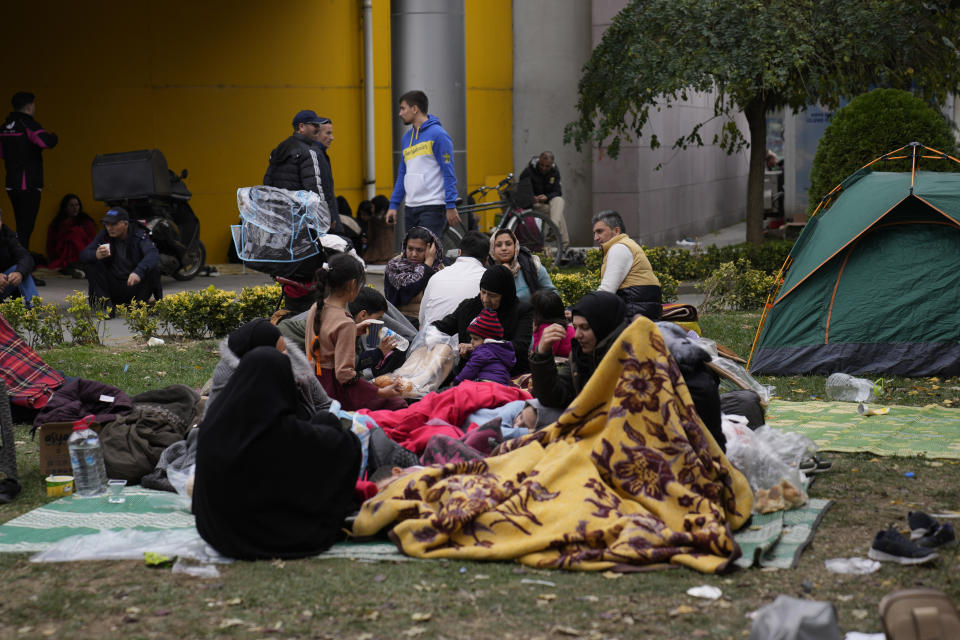 People rest outside their homes in Duzce, Turkey, Wednesday, Nov. 23, 2022, after a magnitude 5.9 earthquake hit a town in northwest Turkey early Wednesday, causing damage to some buildings and widespread panic. At least 68 people were injured, mostly while trying to flee homes. The earthquake was centered in the town of Golkaya, in Duzce province, some 200 kilometers (125 miles) east of Istanbul, the Disaster and Emergency Management Presidency said.(AP Photo/Khalil Hamra)