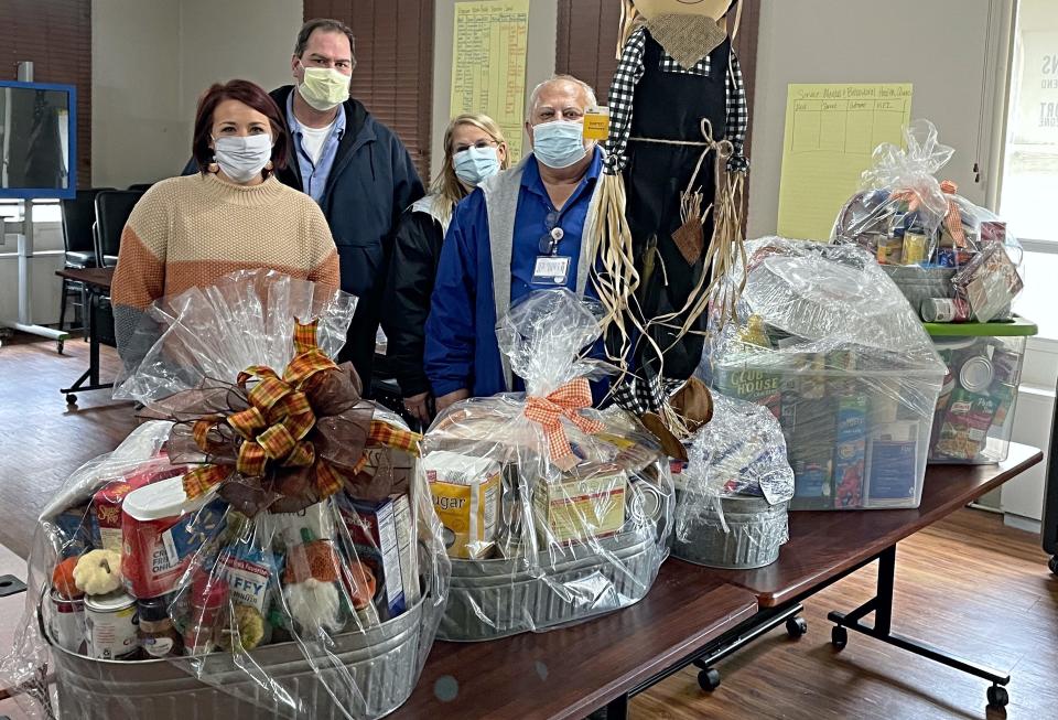 Lincoln Memorial Hospital employees filled 15 baskets with a Thanksgiving feast, including ingredients for a traditional Thanksgiving meal, gift cards and tableware to provide to families in need this holiday. From left are: Breann Titus with Community Action Partnership of Central Illinois, and Nate Benner, Vicki Brickey and Kenny Gill, all with Lincoln Memorial Hospital.