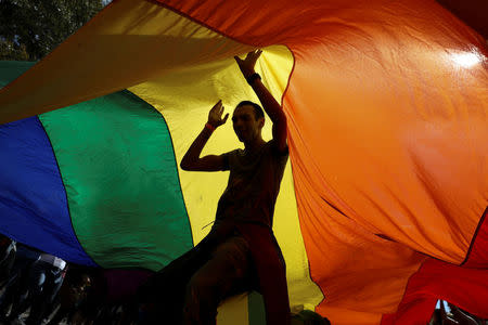 Participants dance under a rainbow flag during an annual LGBT (Lesbian, Gay, Bisexual and Transgender) pride parade in Belgrade, Serbia September 17, 2017. REUTERS/Marko Djurica