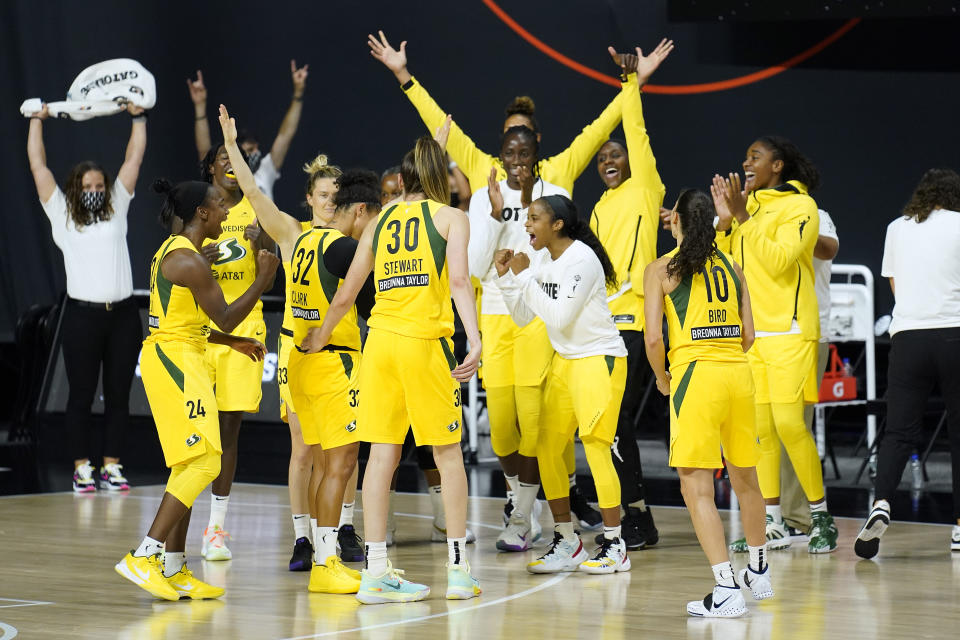 The Seattle Storm celebrate their win over Minnesota Lynx during the second half of Game 1 of a WNBA basketball semifinal round playoff series Tuesday, Sept. 22, 2020, in Bradenton, Fla. (AP Photo/Chris O'Meara)