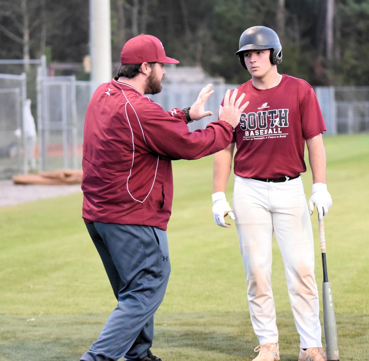 South Effingham's new assistant baseball coach Turner Davis, a former Mustangs player, gives batting instructing to Aaron Benton during some late evening batting cage work.