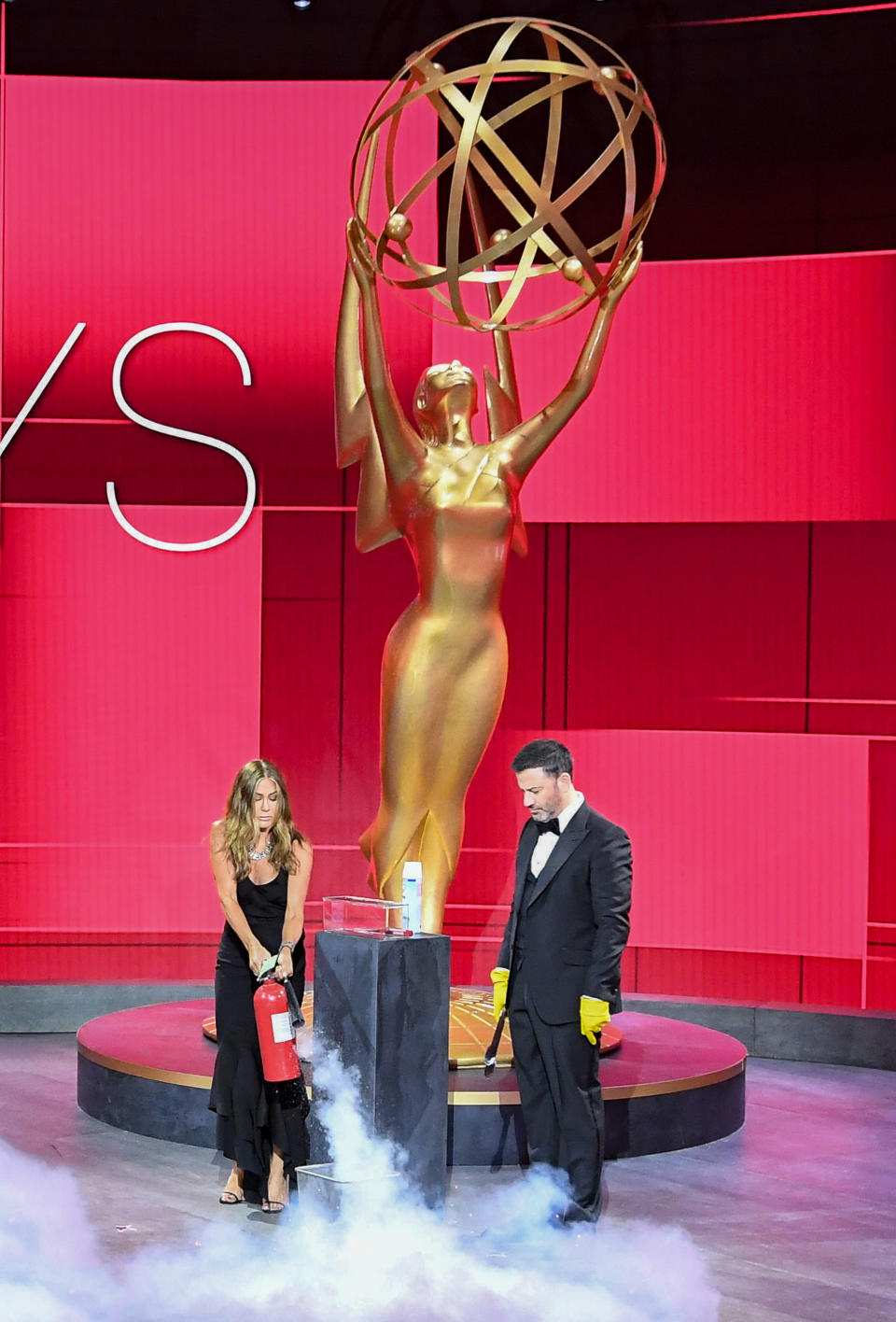 Jennifer Aniston and Jimmy Kimmel make sure the winner's envelope is fully sanitized before presenting the first award at the 72nd Primetime Emmys. (ABC/Image Group)