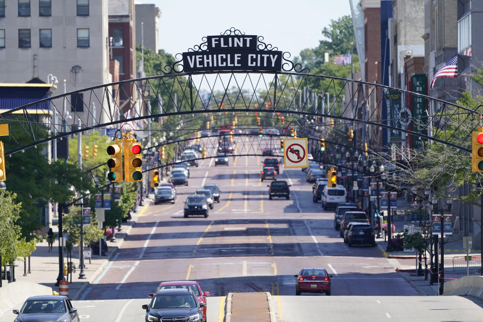 A view of Saginaw Avenue in downtown Flint, Mich, Thursday, Aug. 20, 2020. Michigan Gov. Gretchen Whitmer says a proposed $600 million deal between the state of Michigan and Flint residents harmed by lead-tainted water is a step toward making amends. Officials announced the settlement Thursday, which must be approved by a federal judge. (AP Photo/Carlos Osorio)