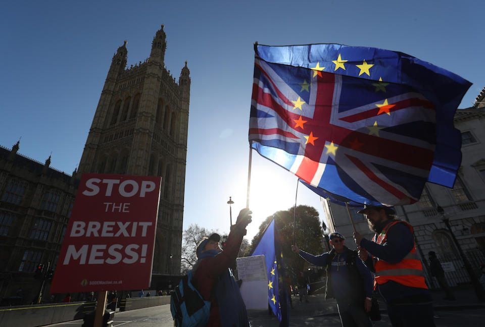 Anti-Brexit campaigners wave Union and European Union flags outside the Houses of Parliament, London (Picture: PA)