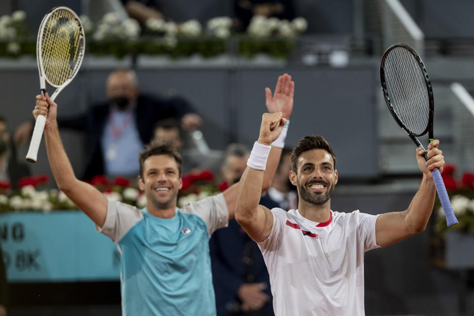 Spain's Marcel Granollers, right, and Horacio Zeballos of Argentina celebrate after winning the men's doubles final match against Croatia's Nikola Mektic and Mate Pavic at the Mutua Madrid Open tennis tournament in Madrid, Spain, Sunday, May 9, 2021. (AP Photo/Bernat Armangue)