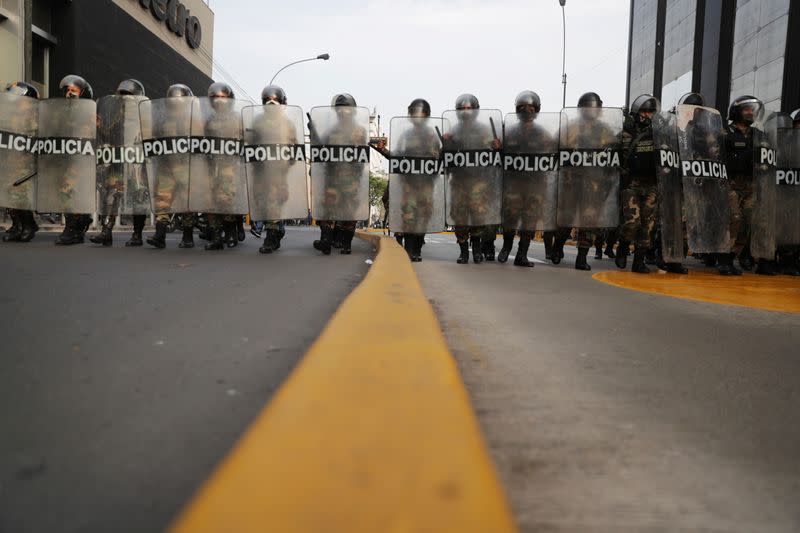 Police officers block the street for approaching demonstrators during protests following the impeachment of President Martin Vizcarra, in Lima