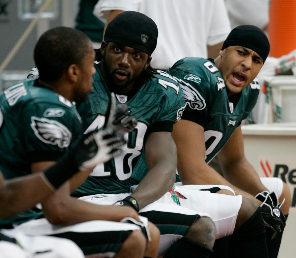 Philadelphia Eagles' Hank Baskett (84) on the bench with teammates Donte Stallworth (18) and Greg Lewis, left, during their NFL football game against the Houston Texans Sunday, Sept. 10, 2006, in Houston.