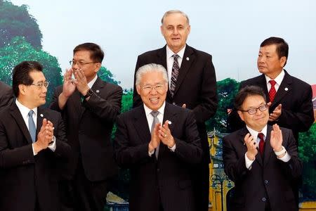 Trade ministers pose for a group photo during the APEC Ministers Responsible For Trade (APEC MRT 23) meeting in Hanoi, Vietnam May 20, 2017. From L-R, front: Hong Kong's Secretary for Commerce and Economic Development Gregory So Kam-leung, Indonesia's Trade Minister Enggartiasto Lukita, Japan's Trade and Industry Hiroshige Seko. From L-R, back: Taiwan's Economic Minister Deng Chen-chung, APEC Secretariat Executive Director Alan Bollard and ABAC Chairman Hoang Van Dung. REUTERS/Kham